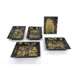 Group of five small Oriental trays with lacquered decoration on a black ground (5)