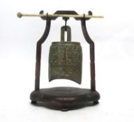 Oriental model of a temple bell in wooden mount