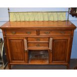 Late 19th century mahogany sideboard having brass rail and curtained back, two long and two short