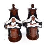 Pair of 20th century pottery book ends, the terracotta bodies brown glazed modelled as judges seated