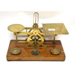 Set of postal scales with weights, on wooden mount, 33cm long