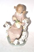 Lladro figure of a young girl with three puppies