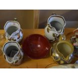 Collection of four Staffordshire jugs with gilt floral design and Prinknash Pottery bowl with red