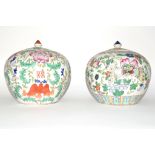 Two Chinese porcelain jars and covers decorated in polychrome with floral design (2)