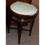 Edwardian period revolving top circular piano stool on four tapering square legs with spade feet,