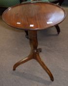 19th century mahogany wine table of circular form with raised edge, the tip-top raised on a turned