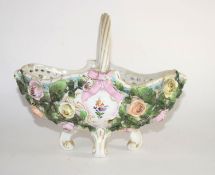 Continental porcelain flower basket on four scroll feet, the sides decorated with flower heads in