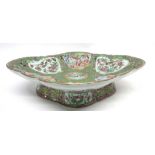 Large 19th century Cantonese dish of lobed shape decorated in typical fashion with panels of Chinese