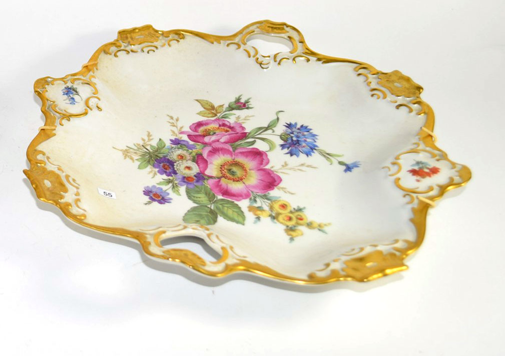 Pair of Continental porcelain dishes decorated in Meissen style of flowers within gilt borders, 30cm