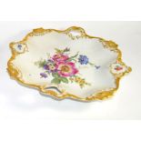 Pair of Continental porcelain dishes decorated in Meissen style of flowers within gilt borders, 30cm