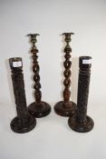 PAIR OF WOODEN BARLEY TWIST CANDELABRA AND TWO FURTHER CANDLE HOLDERS