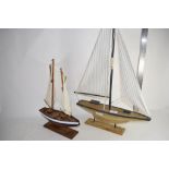 TWO SMALL MODELS OF A POND YACHTS ON WOODEN BASES