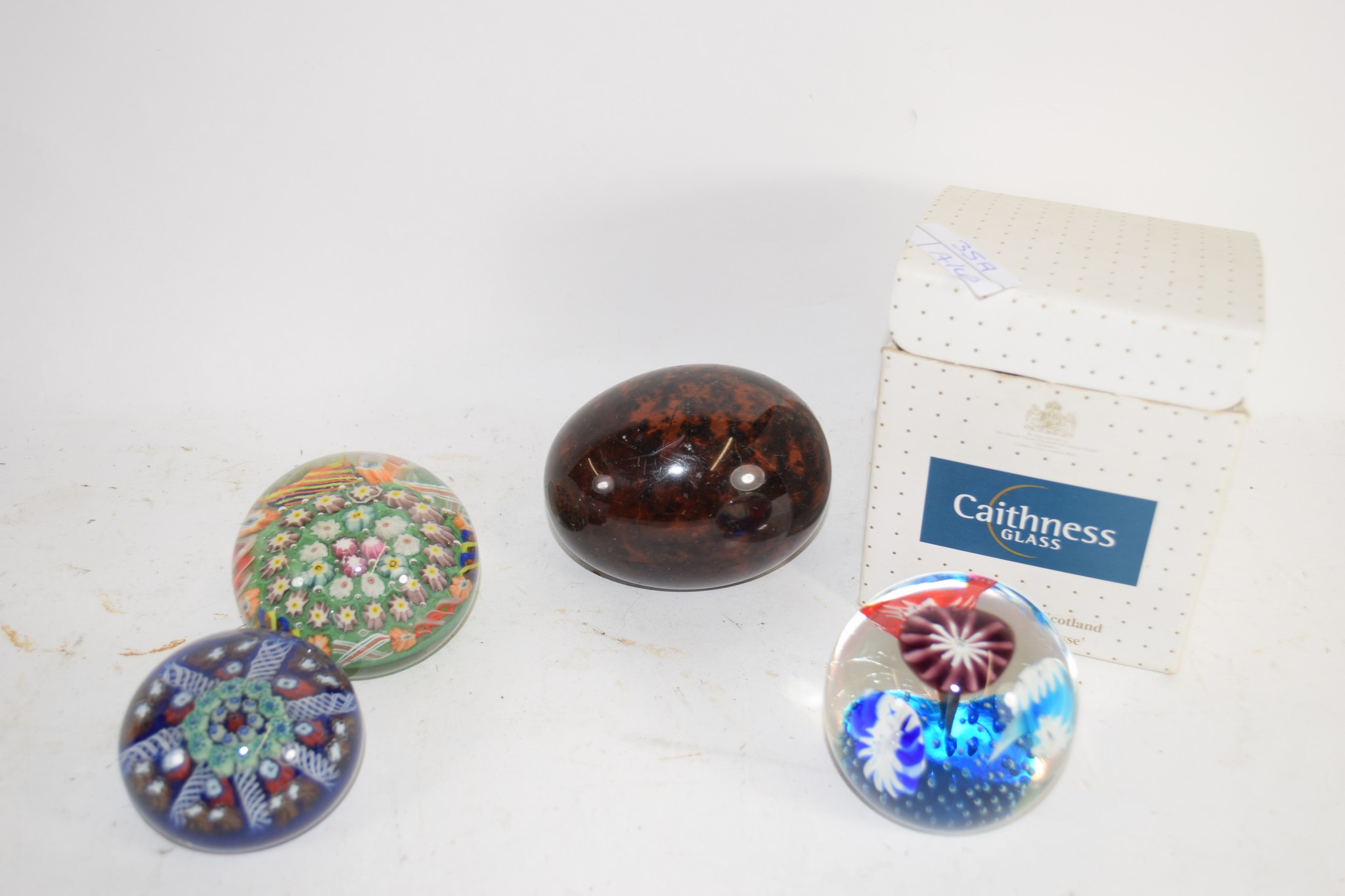 SMALL BOX CONTAINING PAPERWEIGHTS INCLUDING A BOXED CAITHNESS GLASS WEIGHT