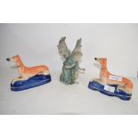 TWO STAFFORDSHIRE PEN HOLDERS MODELLED AS GREYHOUNDS ON BLUE BASES, PLUS A FURTHER CERAMIC FIGURE
