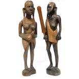 Pair of African carvings, one of a warrior holding a paddle, one of a woman, the pair 38cm high (2)