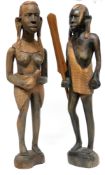 Pair of African carvings, one of a warrior holding a paddle, one of a woman, the pair 38cm high (2)