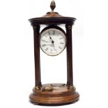Quartz clock in wooden case, supported by four wooden pillars, with brass acorn knop, 27cm high