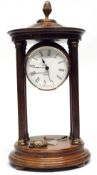 Quartz clock in wooden case, supported by four wooden pillars, with brass acorn knop, 27cm high