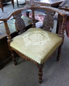 Victorian carved oak corner chair with carved angel mask detail to cresting rail, grotesque mask