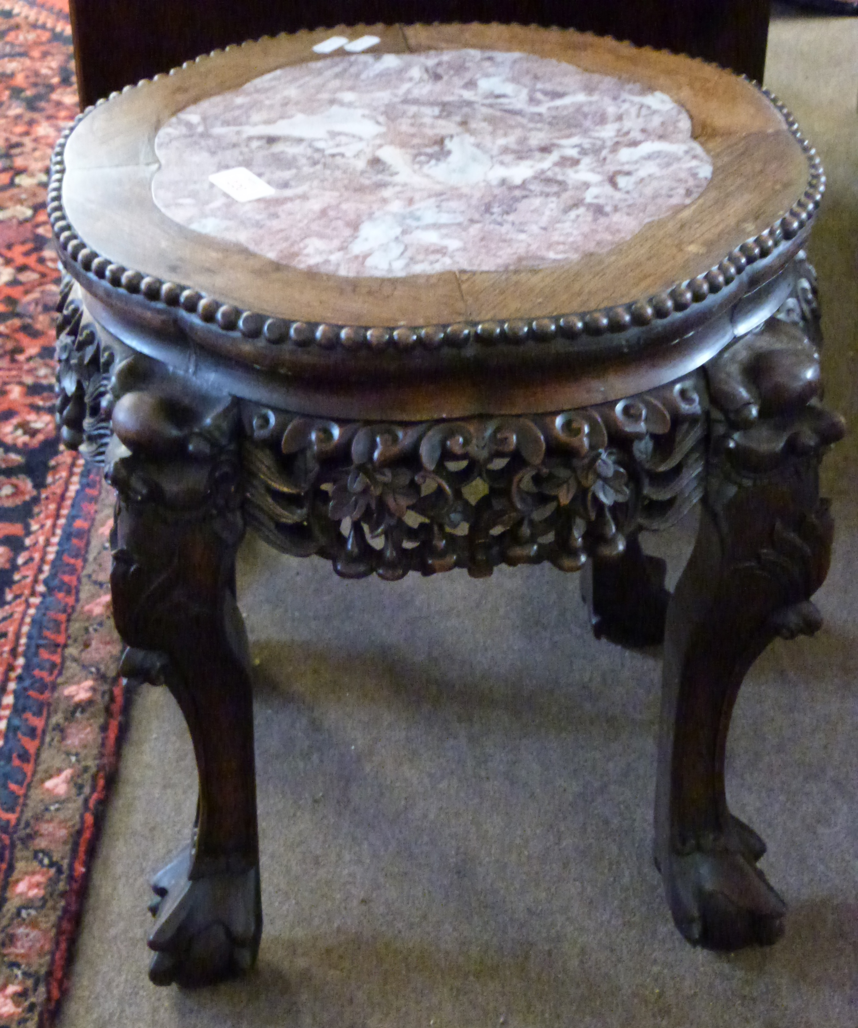 19th century Chinese carved rosewood urn stand of shaped circular form with profusely carved and