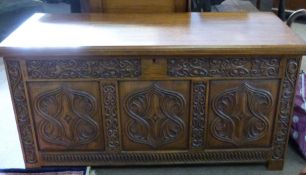 20th century oak coffer with plain lifting lid, the front with three cartouche carved panels and