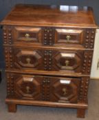 Jacobean style oak cabinet having plain lifting top above a moulded fronted dummy drawer, two double