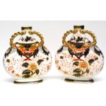 Pair of late 19th century Davenport vases both with an Imari design with gilt handles to neck, the
