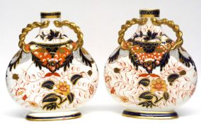 Pair of late 19th century Davenport vases both with an Imari design with gilt handles to neck, the