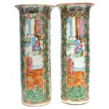 Pair of cylindrical Cantonese vases decorated in a famille rose palette with panels of Chinese