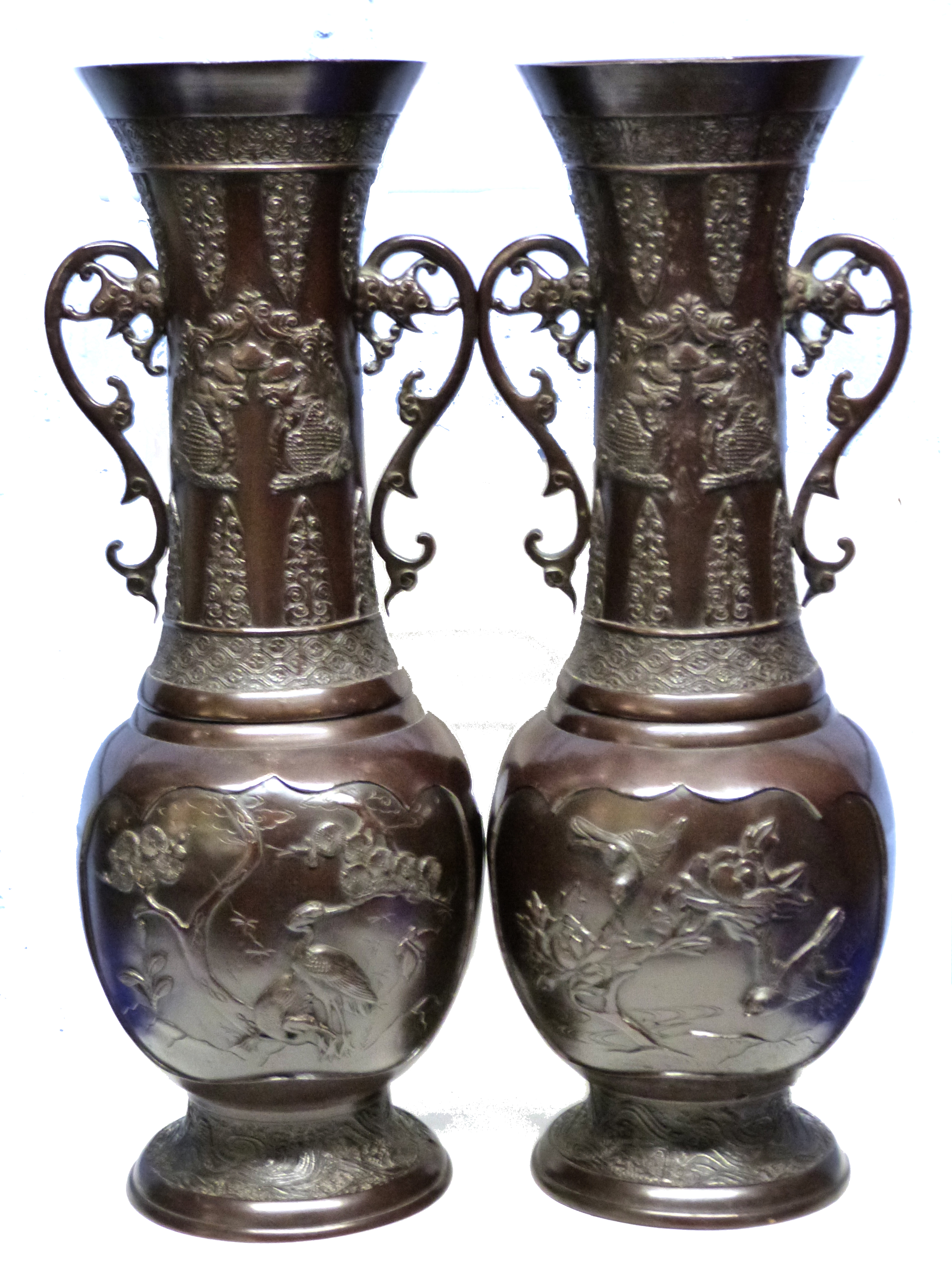 Pair of Japanese bronzed spelter vases decorated in Meiji style with birds and prunus with loop