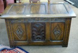 Small 20th century oak coffer with three plain panels to the lifting lid, the front with a diamond
