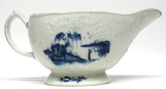 Early Lowestoft porcelain sauce boat, the body with impressed design of flowers bordering two panels