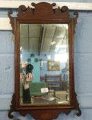 Small 19th century mahogany wall mirror with fret carved and band inlaid decoration, bevelled glass,