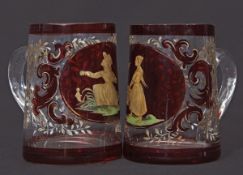 Two small glass tankards decorated in gilt with a young girl feeding birds, the other with a similar