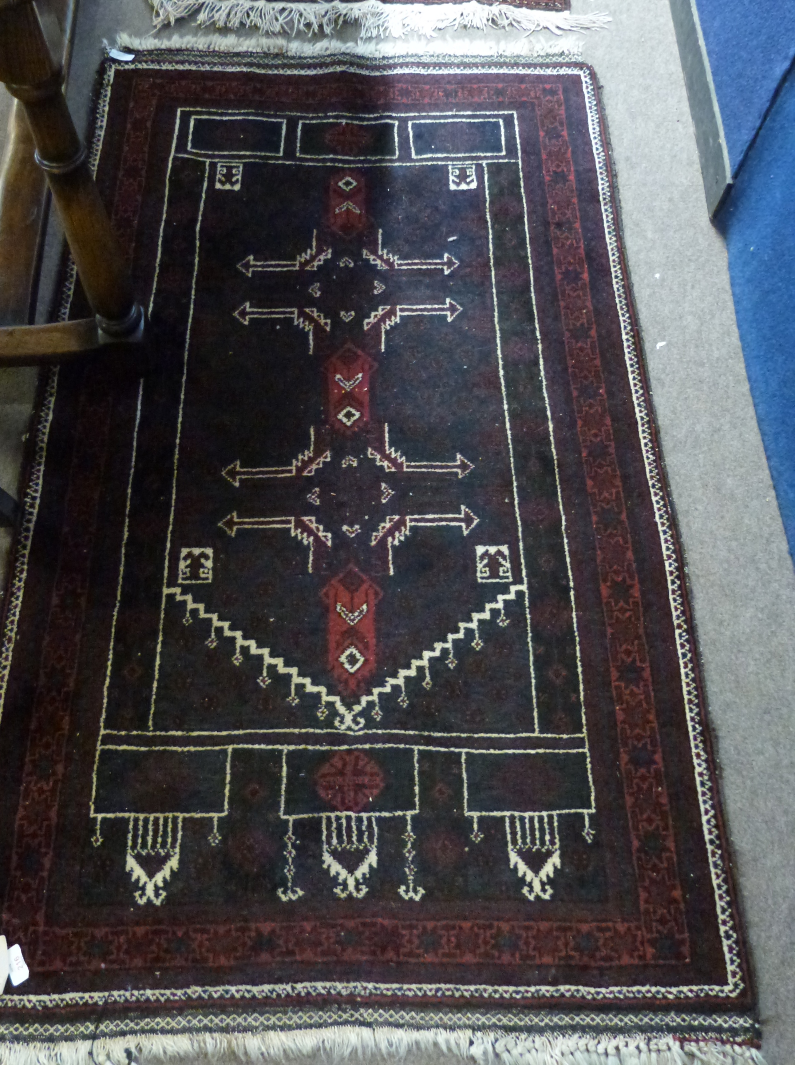 Iranian wool prayer rug in dark blue and cream, to a dark red ground, 151 x 92cm