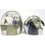 Pair of paperweights with floral designs, one of faceted shape, largest 9cm high