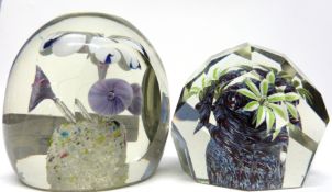 Pair of paperweights with floral designs, one of faceted shape, largest 9cm high