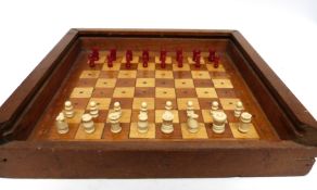 Travelling chess set with chess pieces in white and red