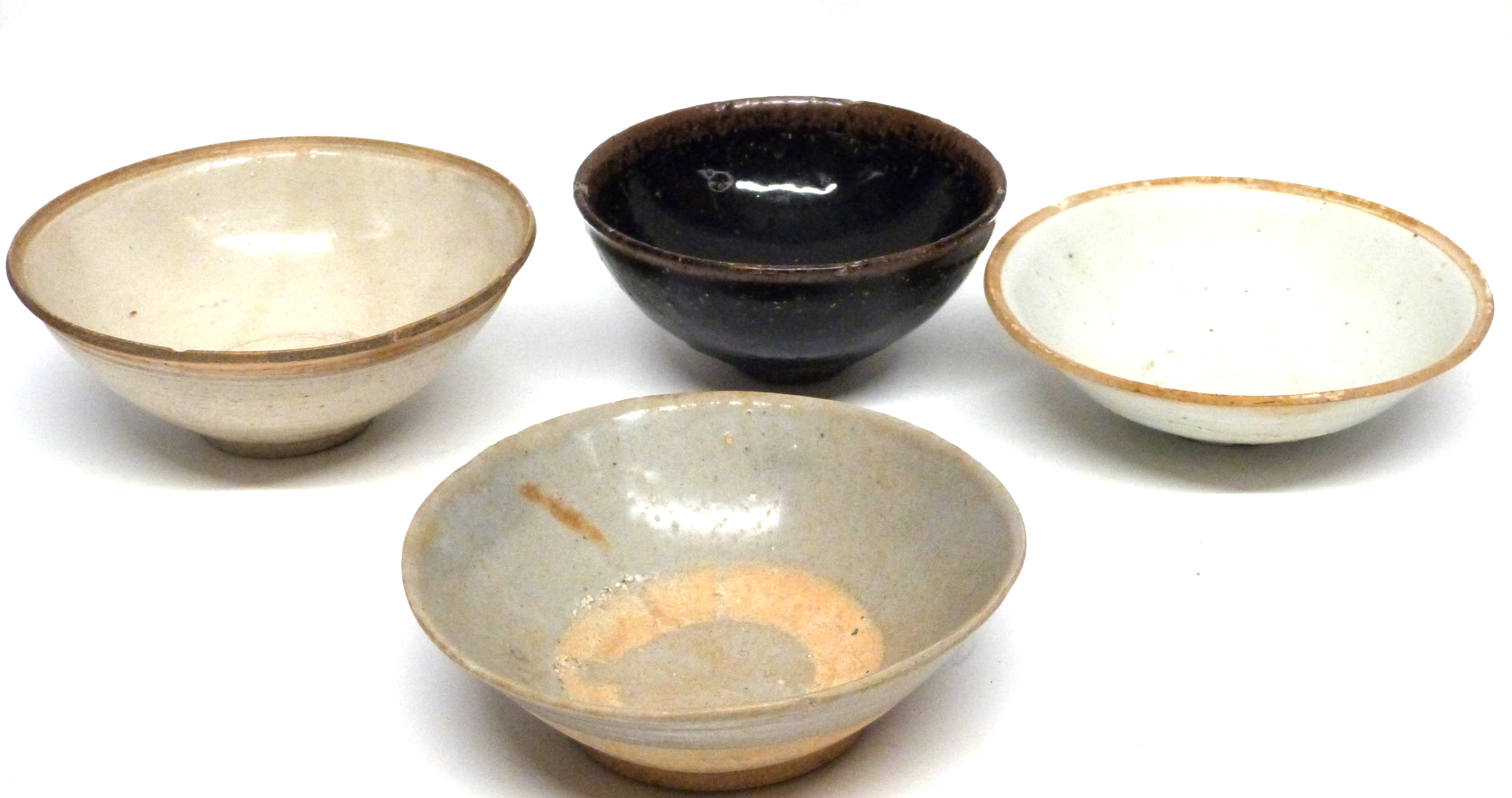 Chinese Song dynasty bowls, one with a Tenmoku type brown speckled glaze and further