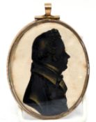 Silhouette of a gent, with lady verso, in gilt metal frame, 8cm long