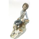 Lladro figure of a young boy with hound by his feet