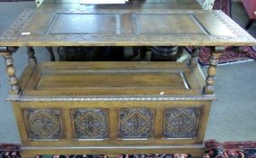 20th century monks oak bench having three bevelled panels to the folding top, lifting plain panelled