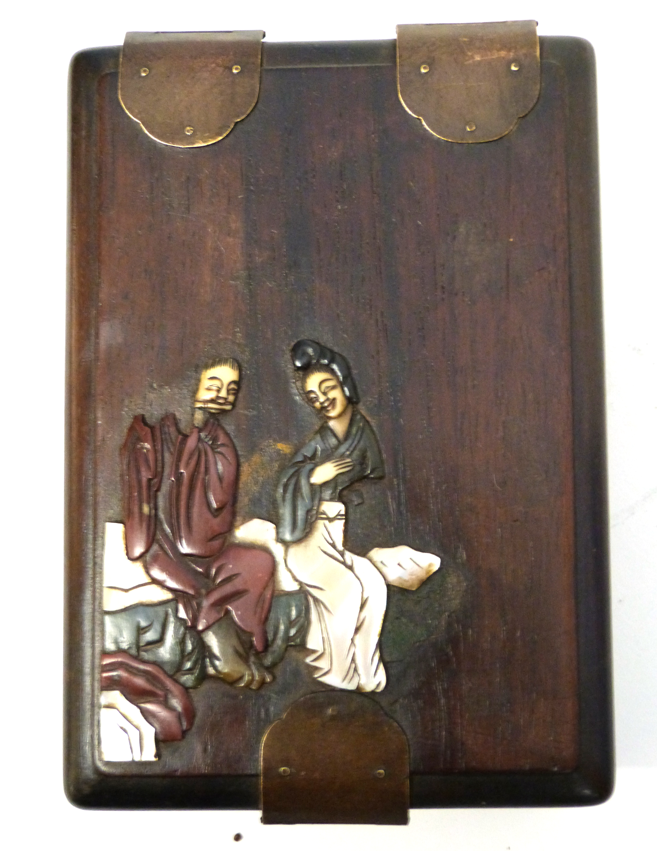 Oriental box with metal strap, the cover modelled in relief with an Oriental couple with metal