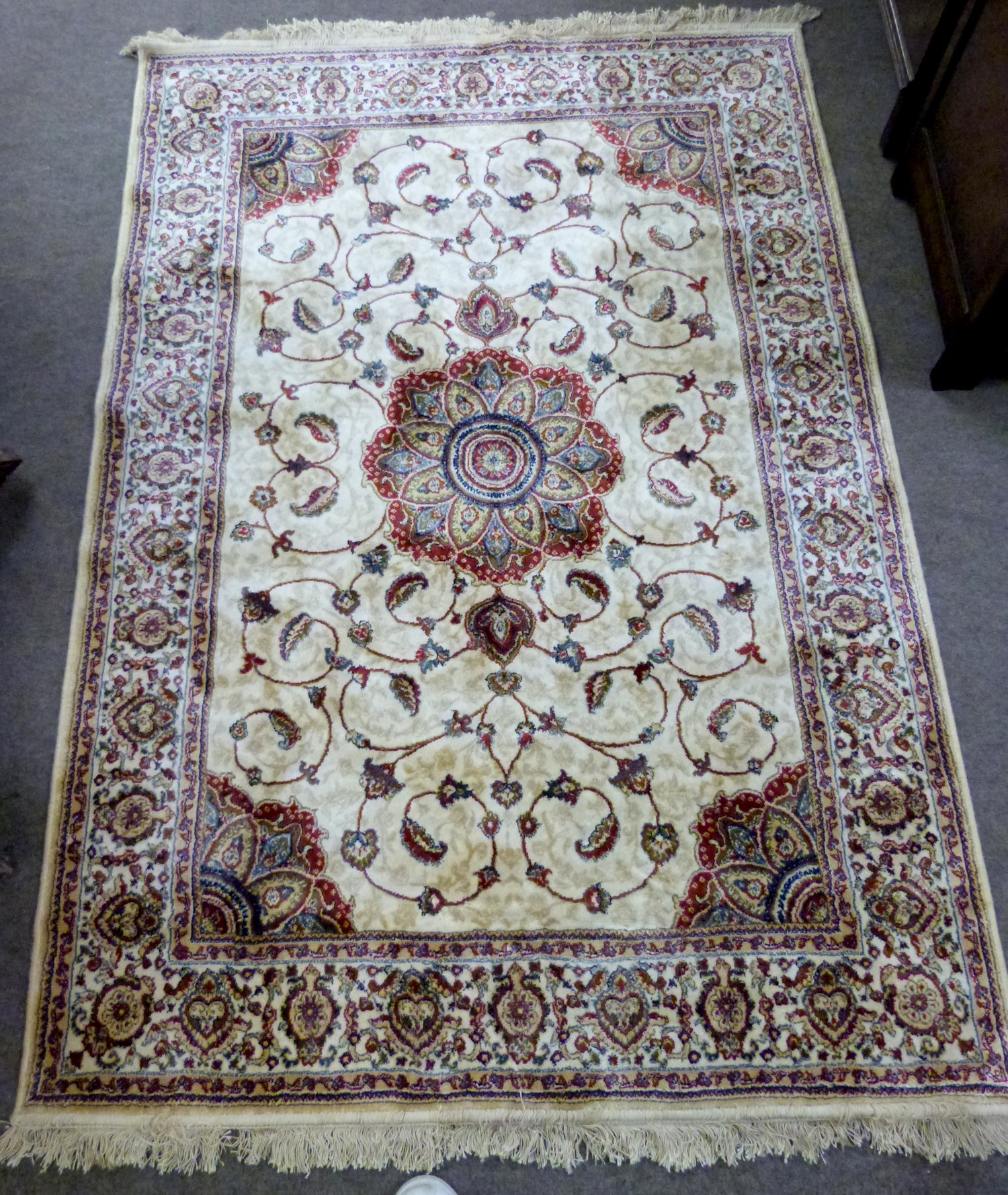 Kashmiri ivory ground full pile rug, with medallion centre, scrolled outer and geometric border, 170