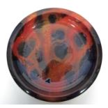 Large Royal Doulton Sung charger with a red and black mottled design, the front signed "F Allen",