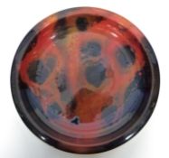 Large Royal Doulton Sung charger with a red and black mottled design, the front signed "F Allen",