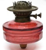 19th century glass lamp font in pink glass of faceted shape with attached burner