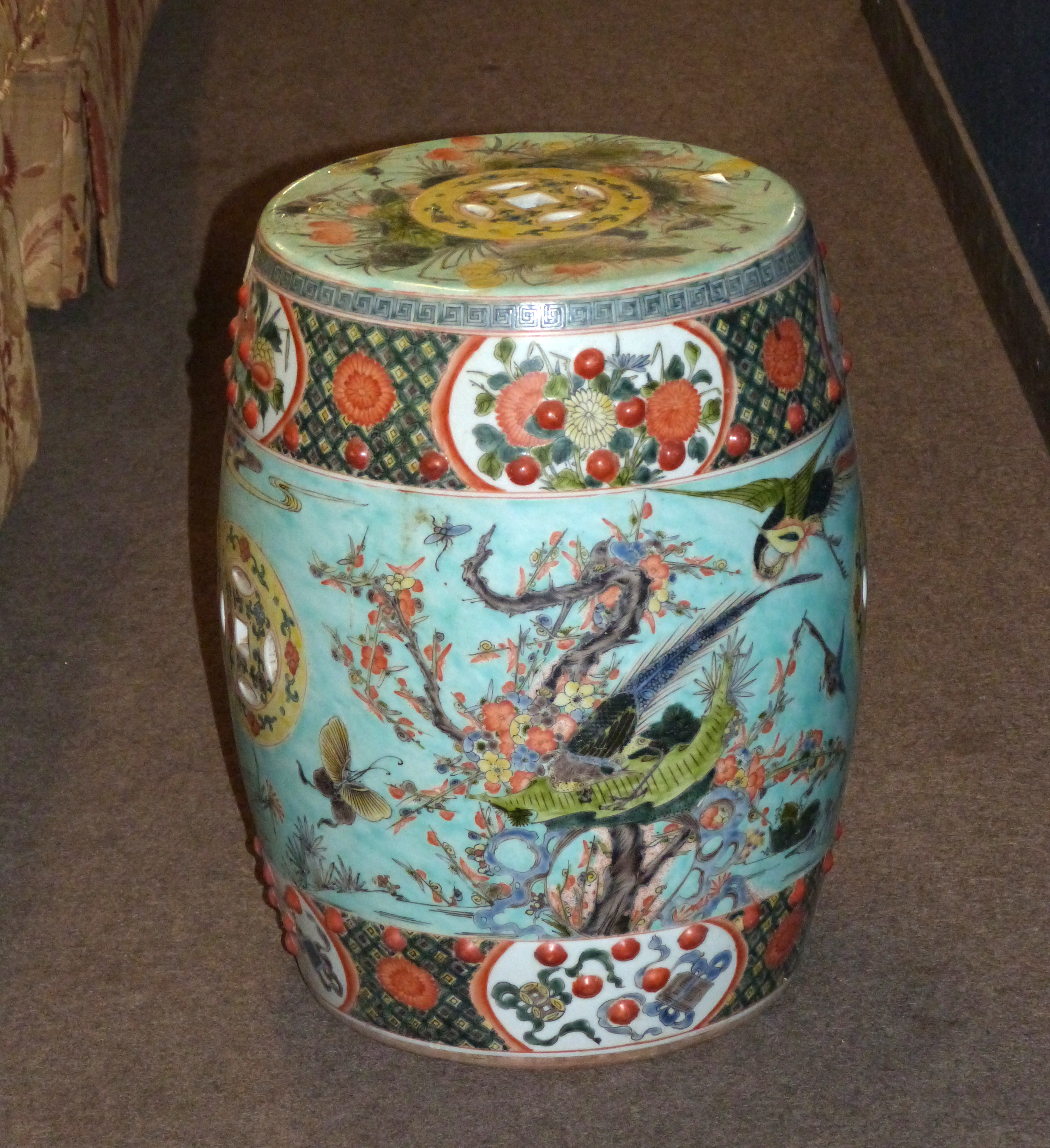 Chinese porcelain garden seat with polychrome decoration of birds amongst foliage with panels