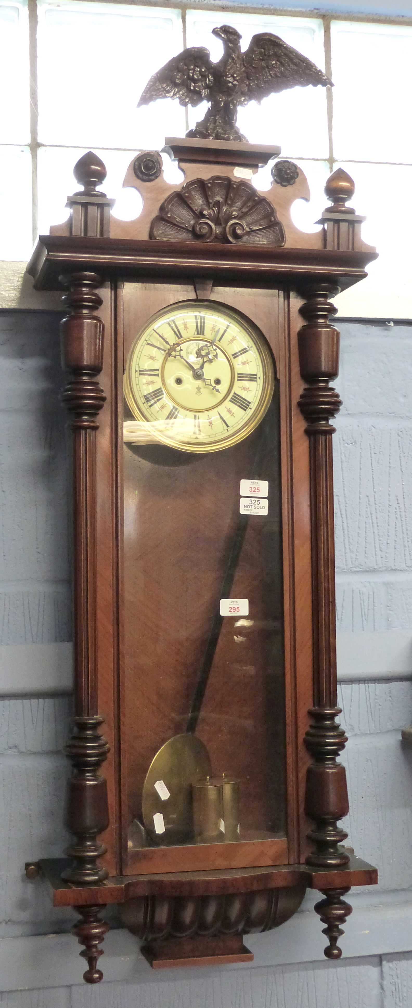 Mahogany cased Vienna type wall clock with eagle crest brass mounted Roman chapter ring within