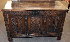 Oak coffer with three panel front and plain interior on stile feet 109cm wide